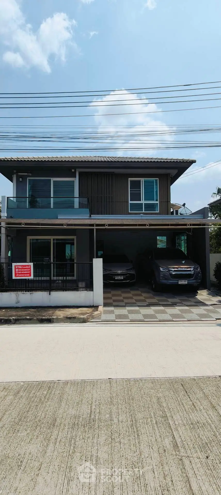 Modern two-story house with spacious driveway and two parked cars