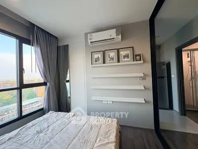 Modern bedroom with large windows and air conditioning, featuring sleek decor and city views.