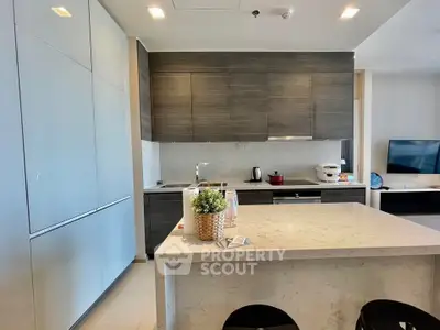 Modern kitchen with sleek cabinetry and marble island in a stylish apartment
