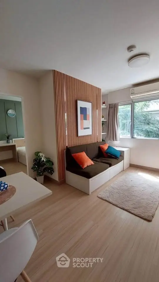 Charming modern living room with cozy seating and natural light, perfect for relaxation and entertaining.