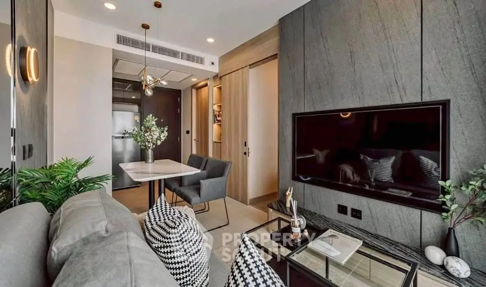 Modern living room with stylish decor, featuring a sleek TV setup and elegant dining area.