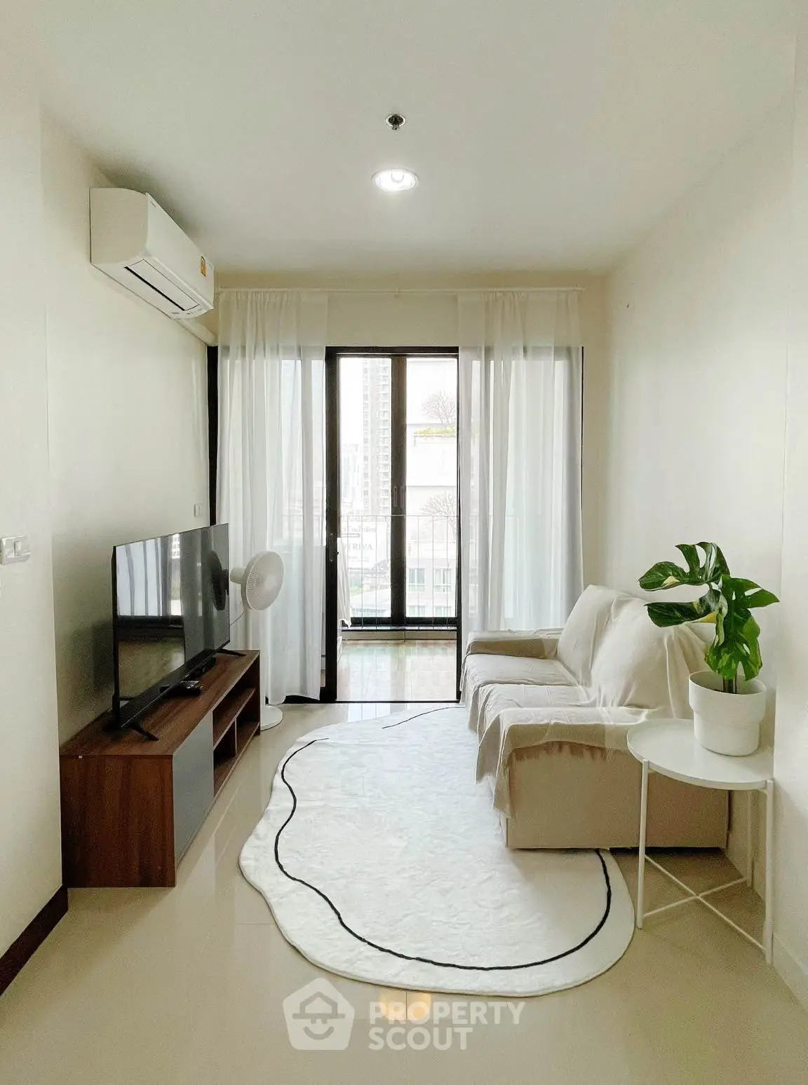Bright living room with modern decor and balcony view