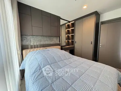 Modern bedroom with stylish cabinetry and cozy bedding in a contemporary apartment.