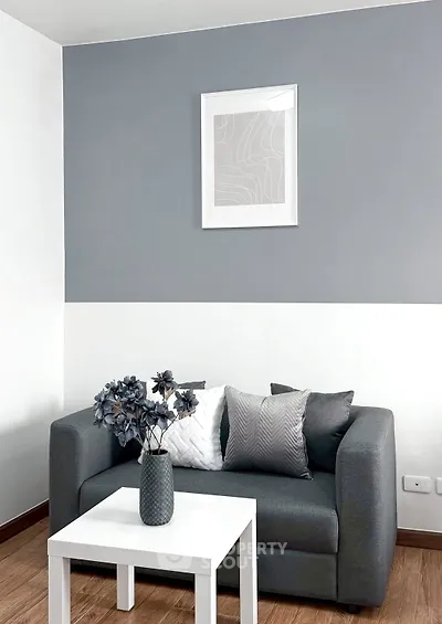 Modern living room with stylish gray sofa and decorative pillows