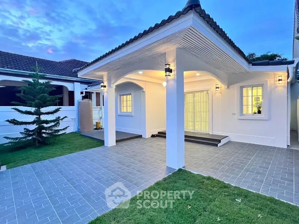 Charming modern home exterior with elegant lighting and spacious driveway at dusk.
