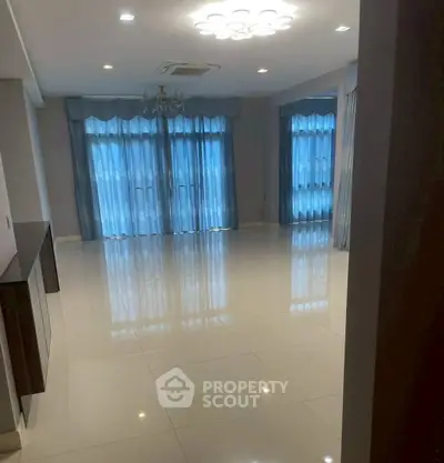 Spacious living room with elegant curtains and modern lighting