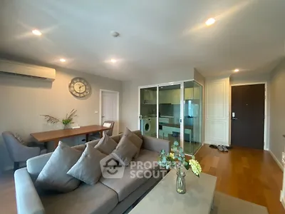 Modern living room with cozy sofa and open kitchen layout