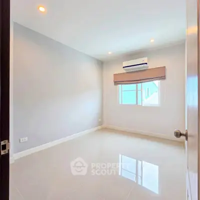 Spacious empty bedroom with air conditioning and natural light