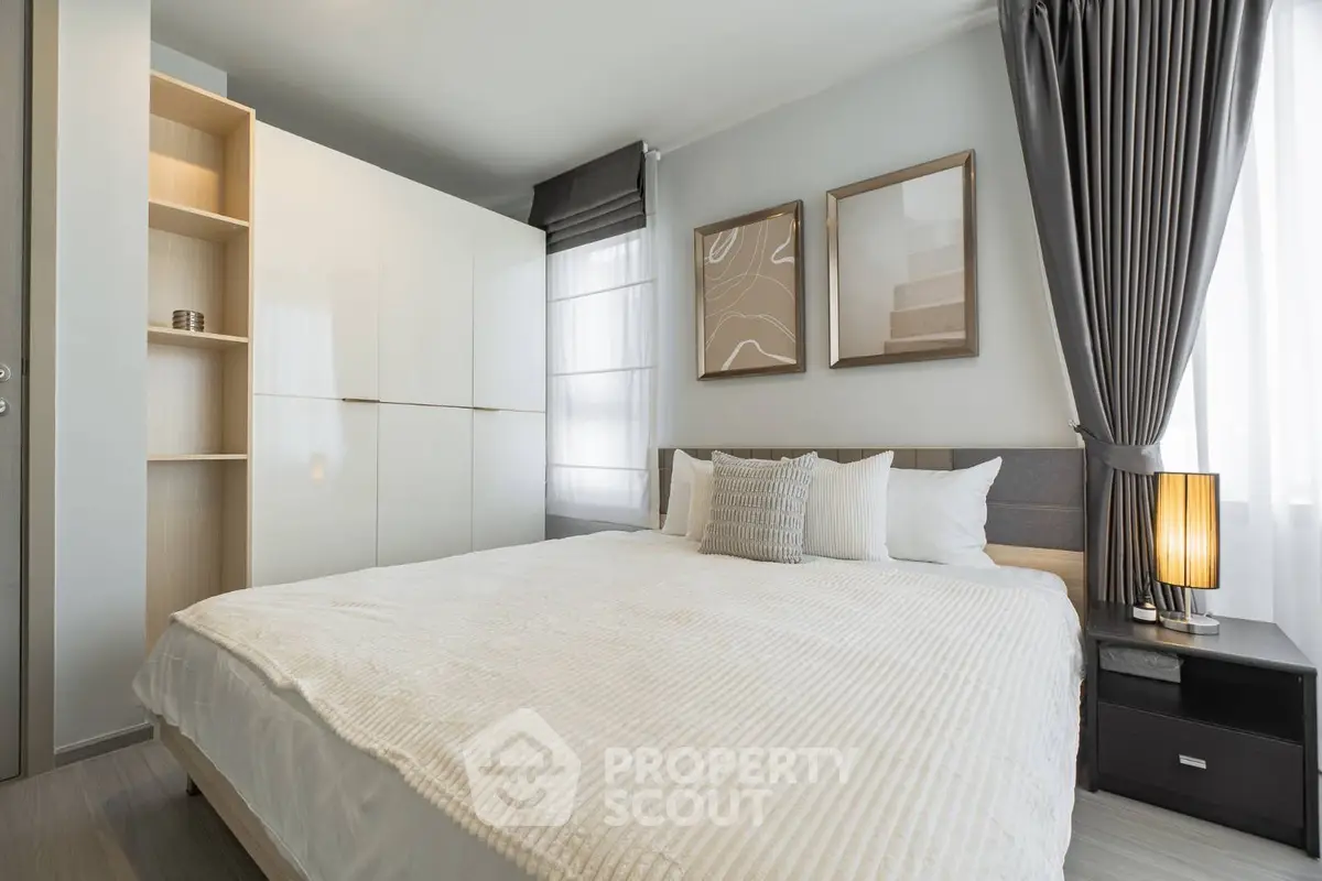 Modern bedroom with stylish decor and ample natural light