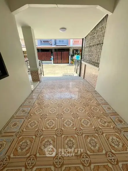 Charming entrance with intricate tile flooring and open view to the street.