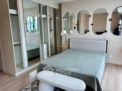 Modern bedroom with mirrored closets and stylish decor