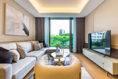 Luxurious living room with modern decor and stunning city view from balcony.