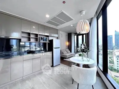 Modern open-layout kitchen and living area with city view, sleek cabinetry, and stylish lighting.