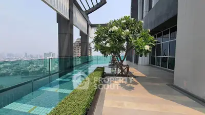 Luxurious rooftop pool with stunning city view and lush greenery