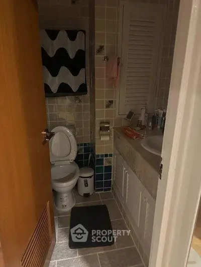 Cozy bathroom with modern fixtures and stylish tile design, perfect for a compact living space.