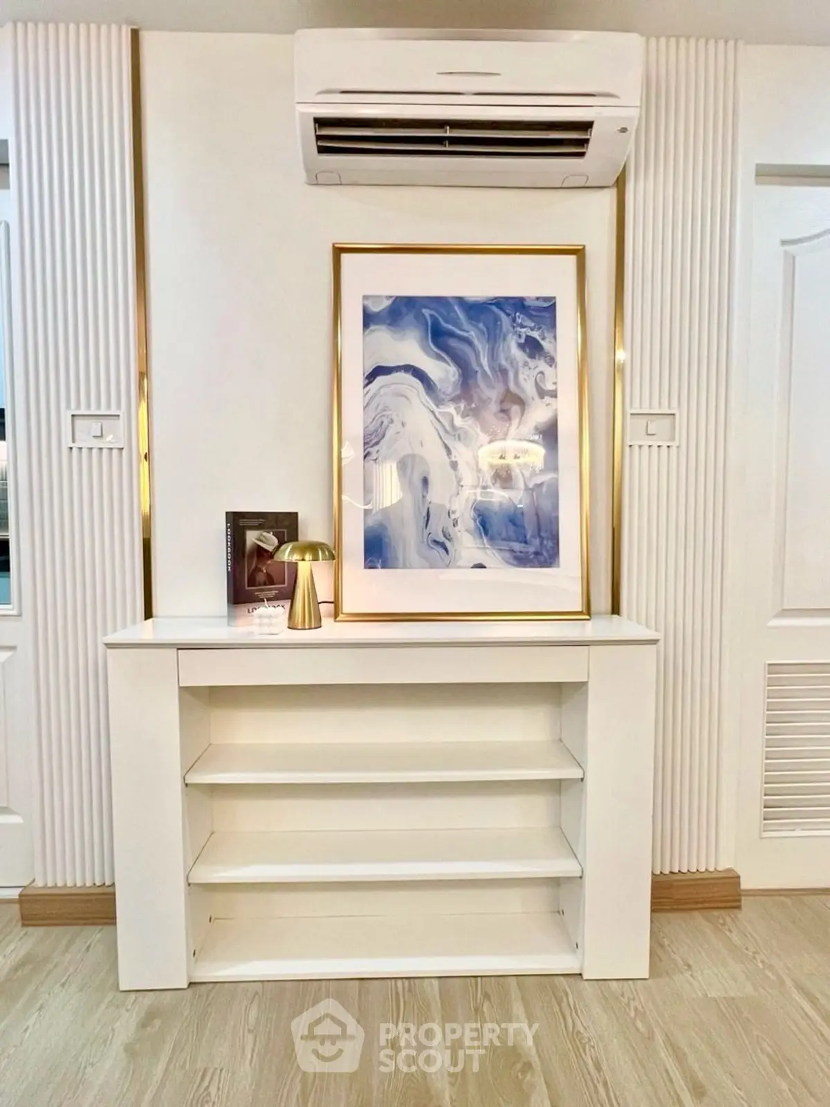 Stylish modern interior with elegant wall art and sleek shelving unit.