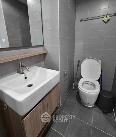 Modern bathroom with sleek fixtures and gray tile design
