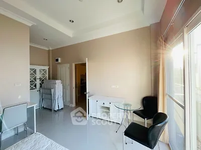 Bright and airy bedroom with modern furnishings and large windows for natural light.