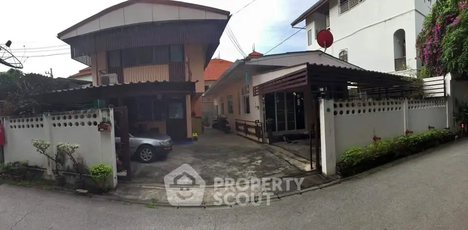 Charming suburban house with driveway and carport, perfect for family living.