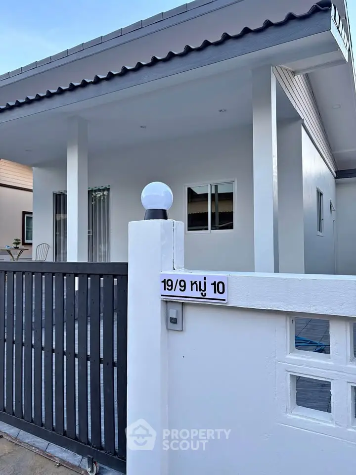 Charming modern house with sleek exterior and gated entrance, perfect for comfortable living.