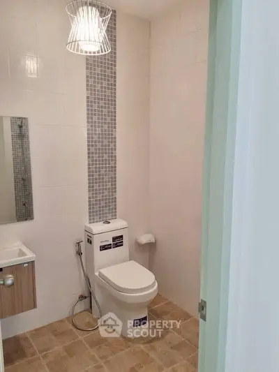 Modern bathroom with stylish lighting and sleek fixtures.