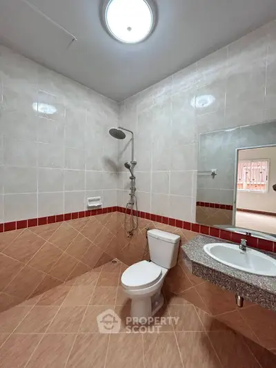 Spacious bathroom with modern fixtures and elegant tile design