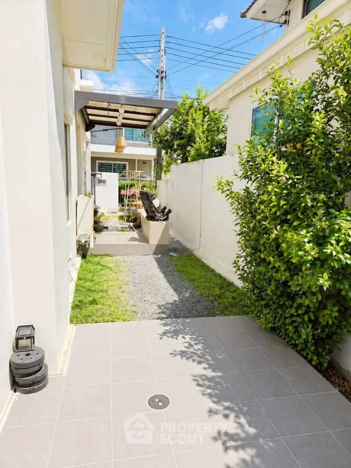 Charming outdoor garden area with modern landscaping and cozy seating, perfect for relaxation and entertaining.