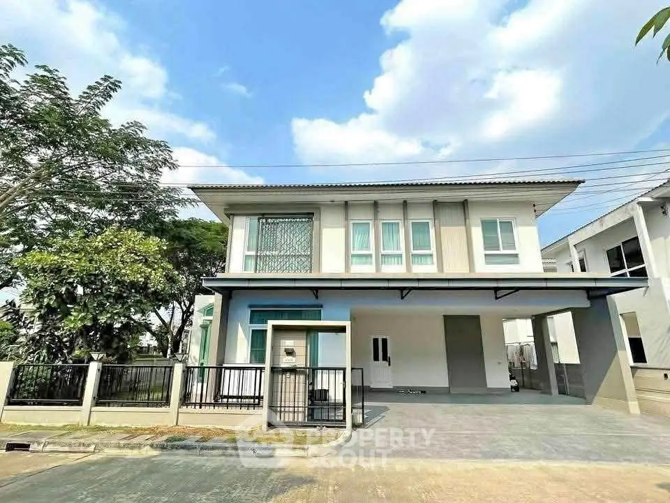 Modern two-story house with spacious driveway and contemporary design in a serene neighborhood.