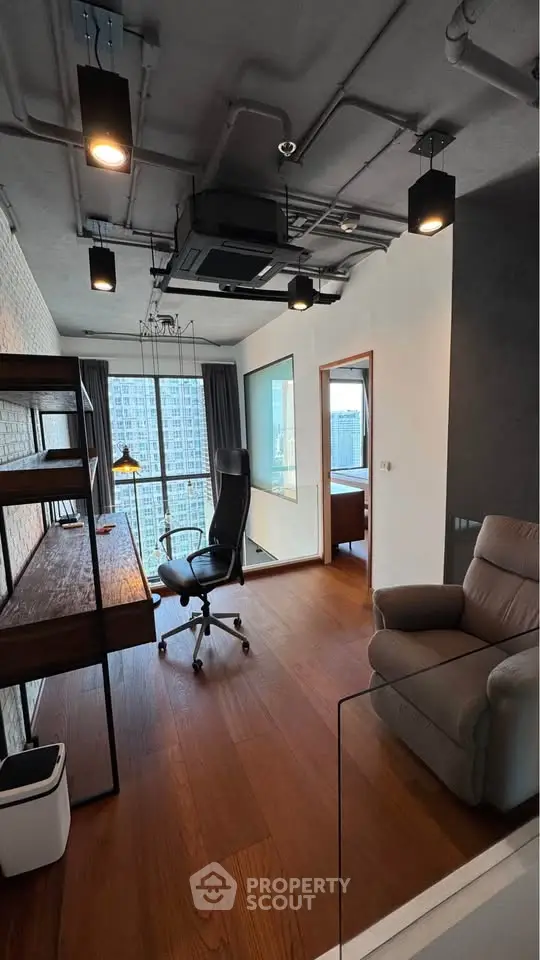 Modern study room with city view, featuring sleek furniture and wooden flooring.