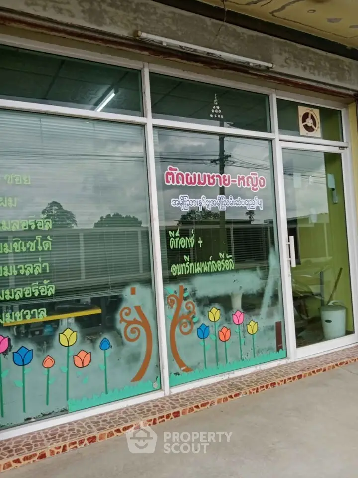 Charming storefront with colorful floral window design and welcoming entrance.