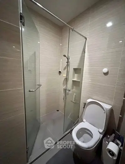 Modern bathroom with glass shower and sleek toilet design