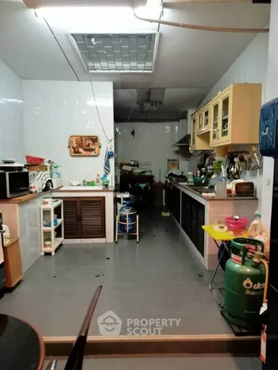 Spacious kitchen with closed layout and modern appliances, ideal for culinary enthusiasts.