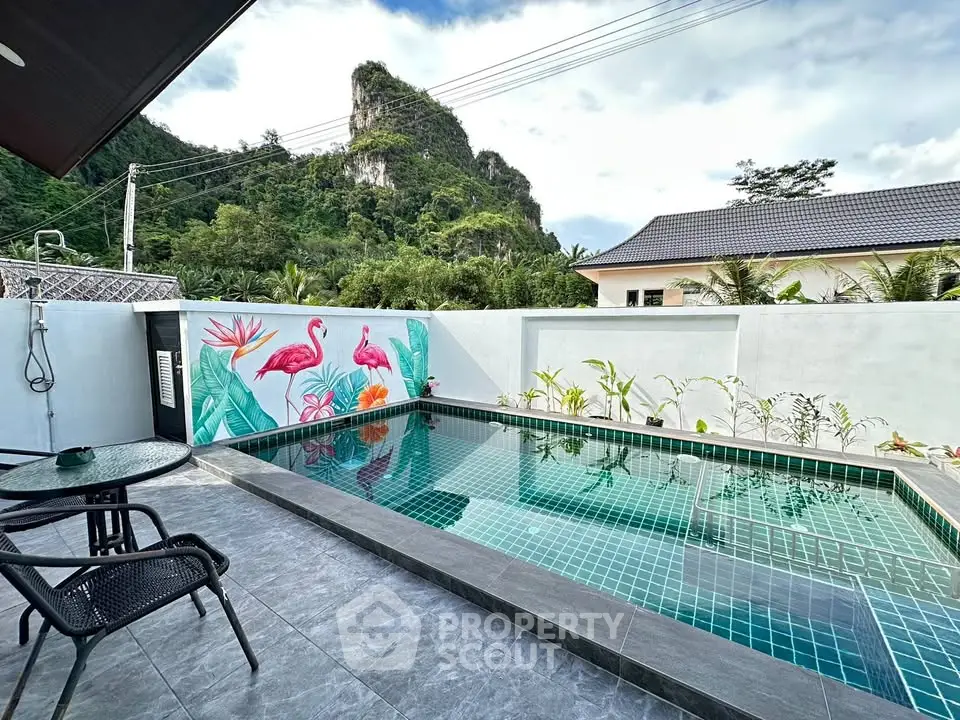 Stunning private pool with scenic mountain view and vibrant mural in a serene outdoor setting.