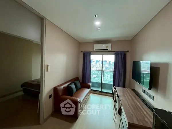Modern living room with city view, sleek furniture, and balcony access in a stylish apartment.