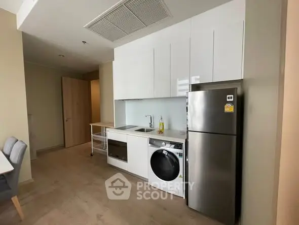 Modern kitchen with sleek appliances and compact design