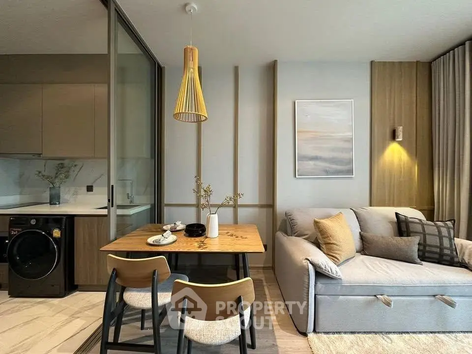 Modern living room with cozy sofa, dining table, and stylish decor in a contemporary apartment.