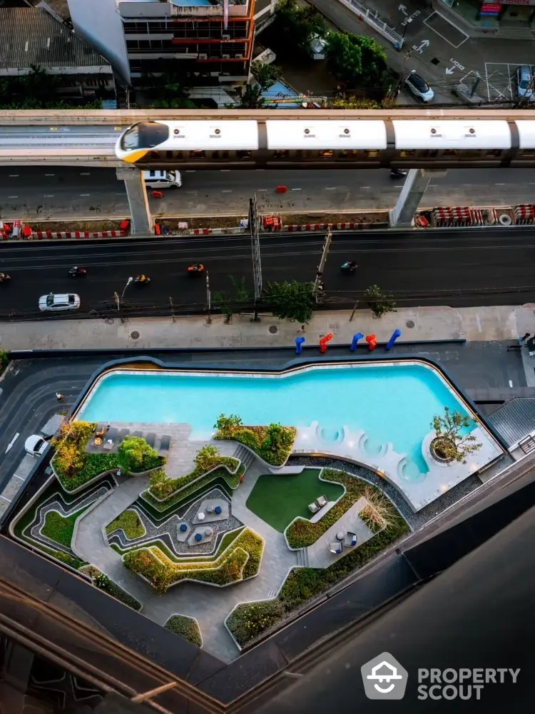 Stunning aerial view of modern building with rooftop pool and lush garden, perfect for urban living.