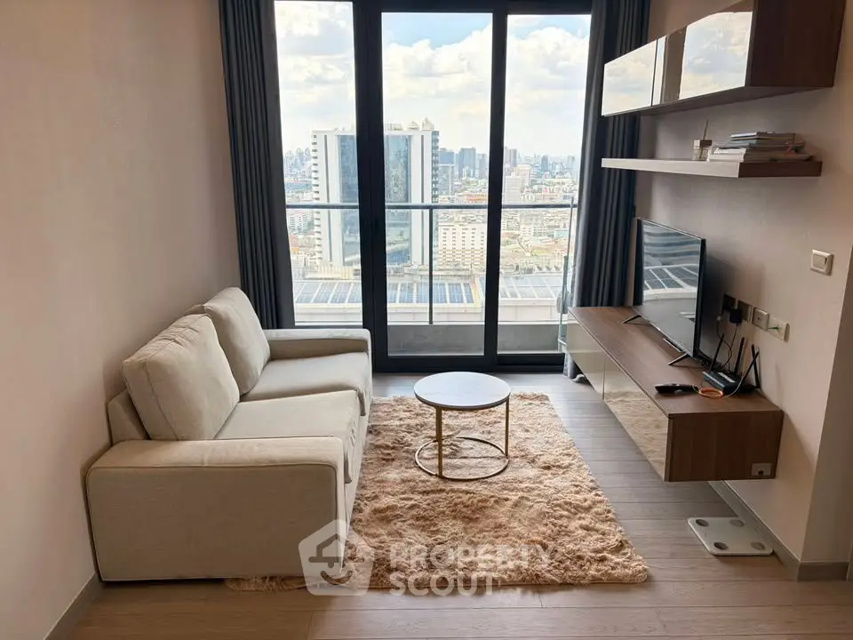 Modern living room with city view, featuring cozy sofa, stylish shelves, and large windows for natural light.