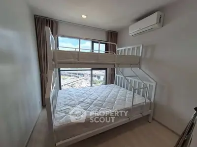 Modern bedroom with bunk bed and large window offering city view.