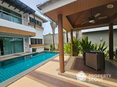 Luxurious modern villa with private pool and stylish outdoor seating area, perfect for relaxation.