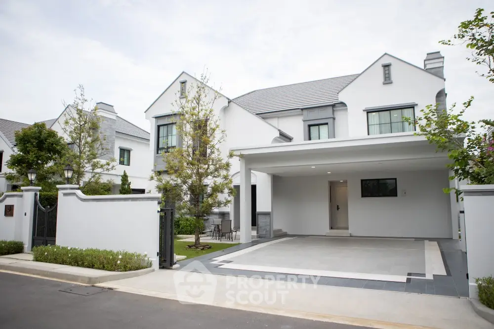 Elegant modern house with spacious driveway and lush greenery