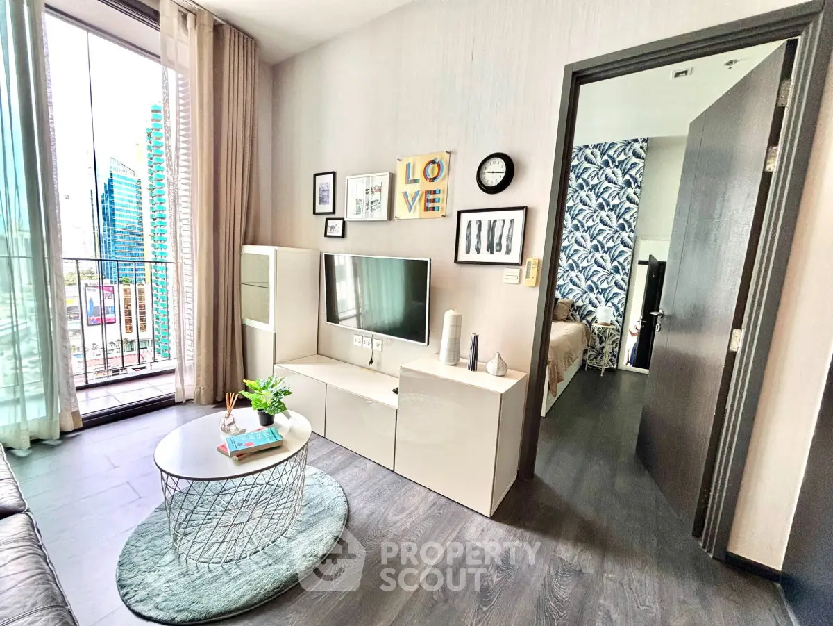 Modern living room with stylish decor and balcony view in a high-rise apartment