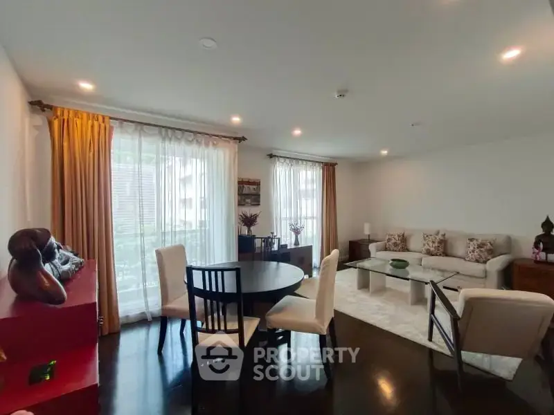 Spacious living room with elegant decor and large windows for natural light.