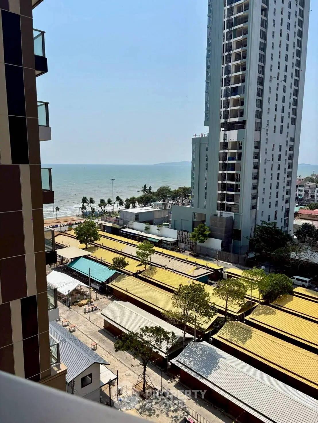 Stunning ocean view from high-rise apartment balcony with modern architecture