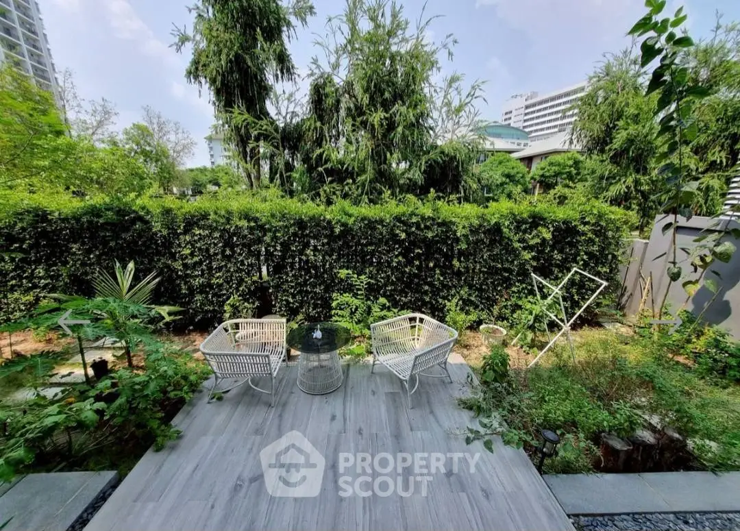 Charming garden view with modern outdoor seating and lush greenery