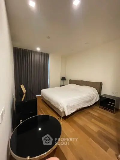 Modern bedroom with wooden flooring and elegant furnishings