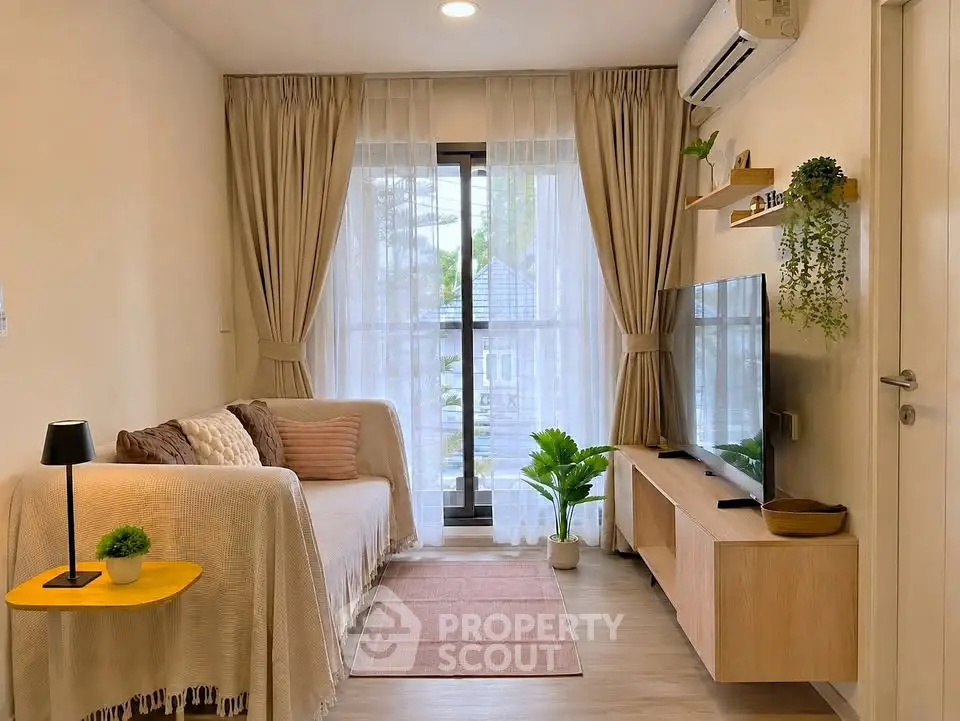 Cozy living room with modern decor, large window, and stylish furniture in a bright apartment.