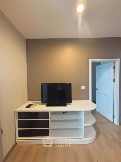 Modern living room with sleek TV stand and wooden flooring, perfect for cozy entertainment.
