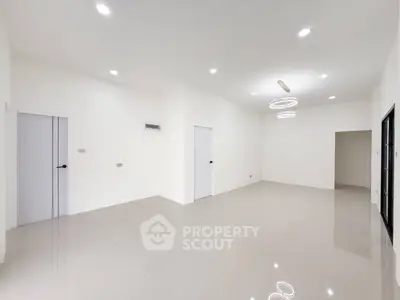 Spacious modern living room with sleek tile flooring and elegant lighting