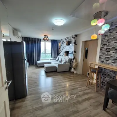 Modern living room with stylish decor and large windows offering natural light.